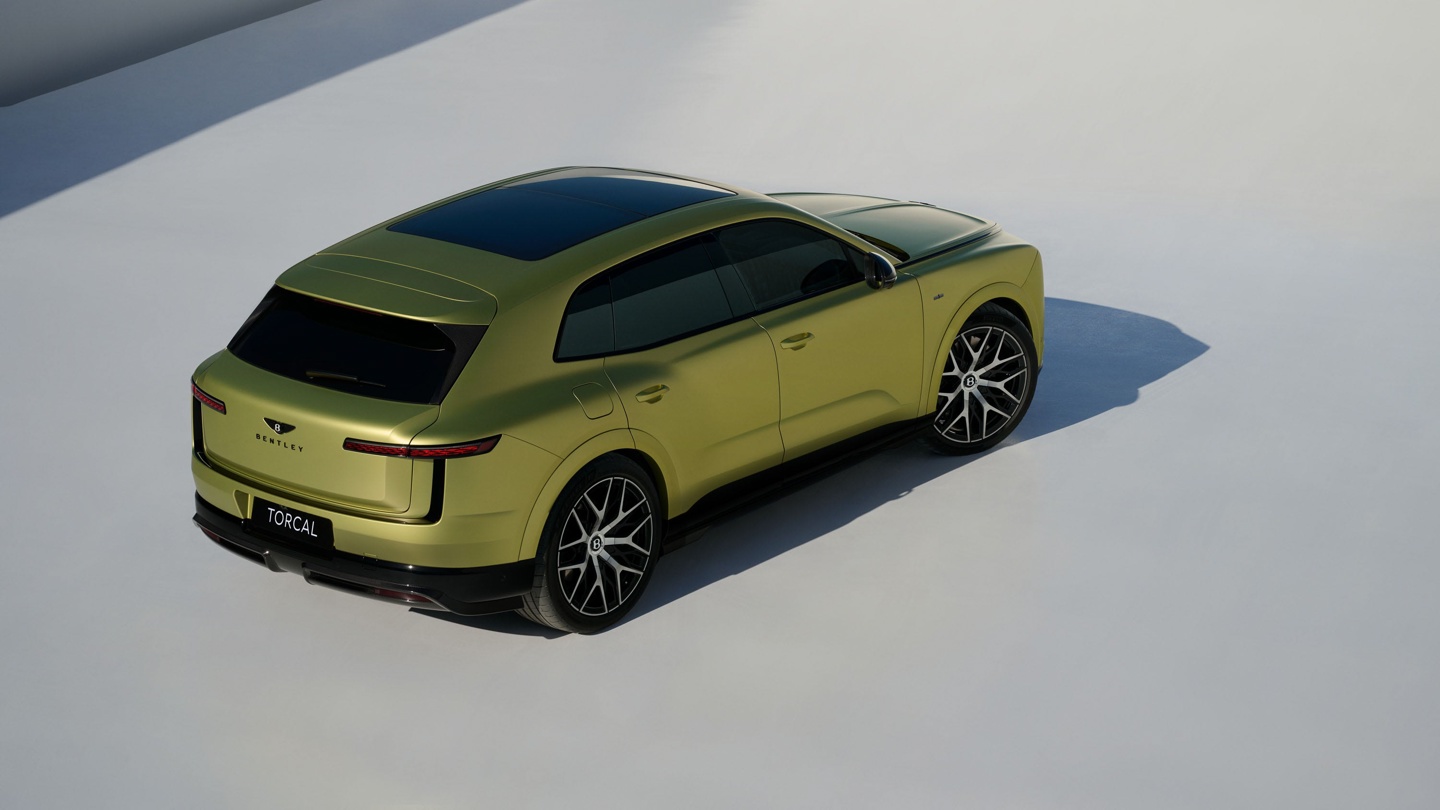 A stylish lime green luxury SUV with a sleek design and prominent wheels displayed against a minimalist background.