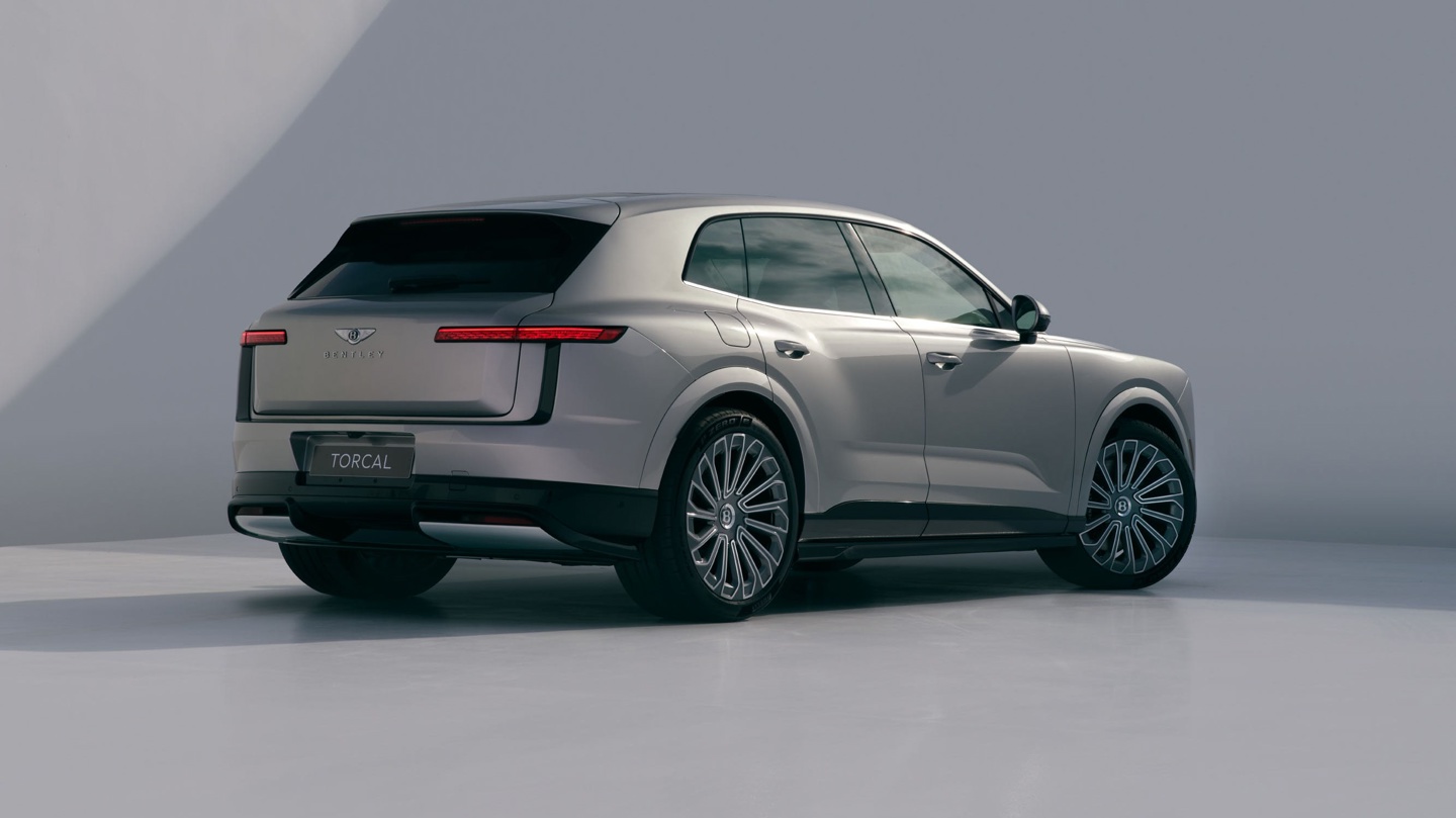 Luxury SUV with a sleek design, showcasing elegant lines and distinctive rear lighting against a minimalist backdrop.