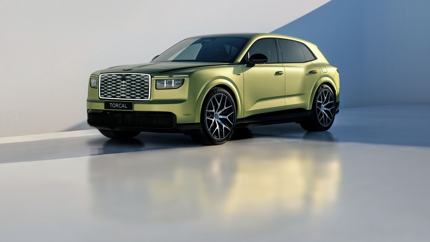 Stylish yellow SUV parked against a minimalist backdrop with soft lighting and reflections.