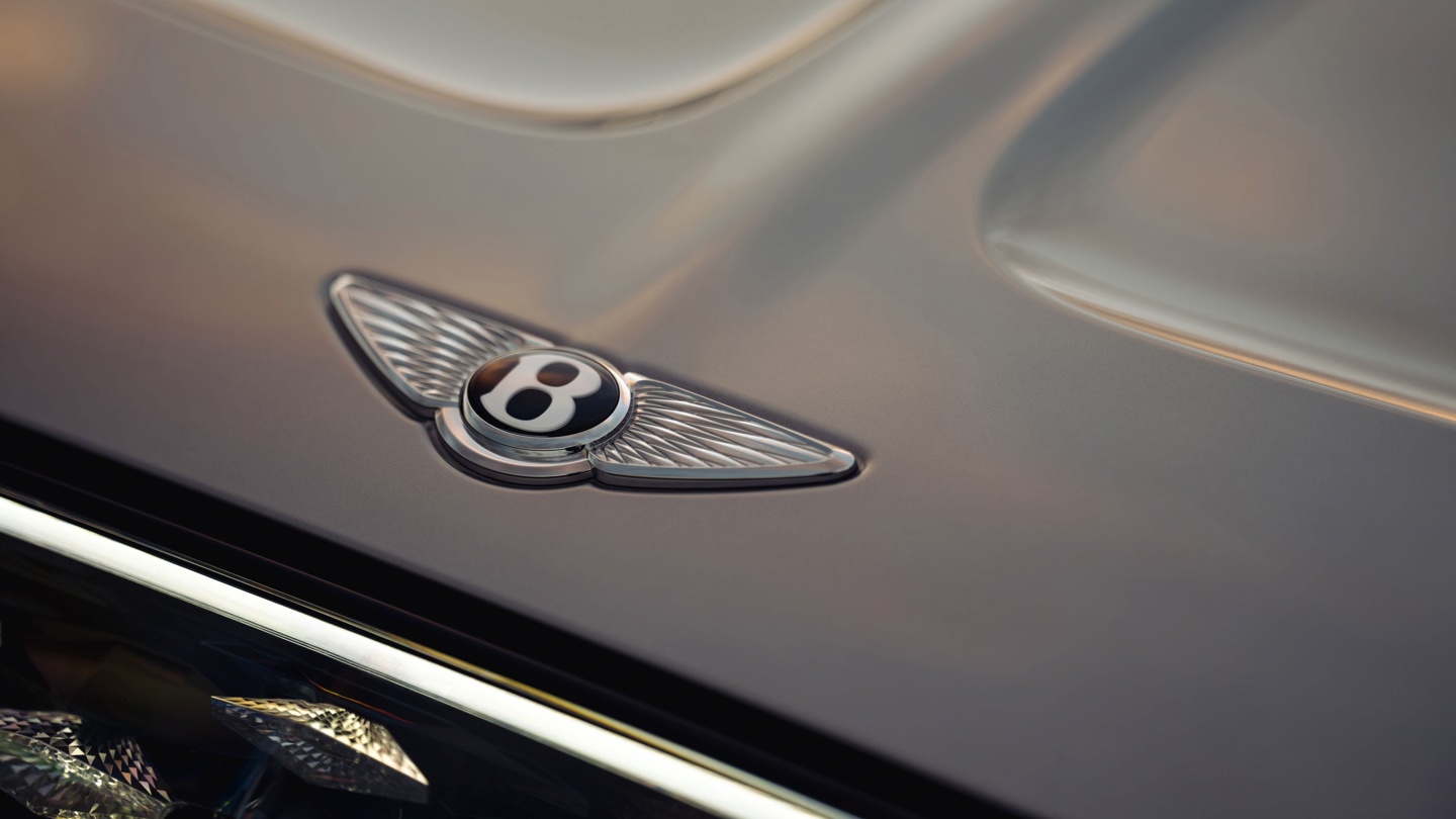 Bentley emblem with wings on a car hood.