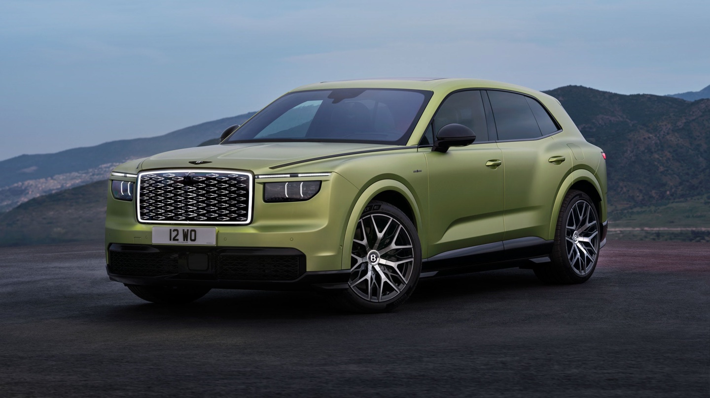 Luxury SUV in unique green color with distinctive grille and sporty wheels, set against a scenic backdrop.